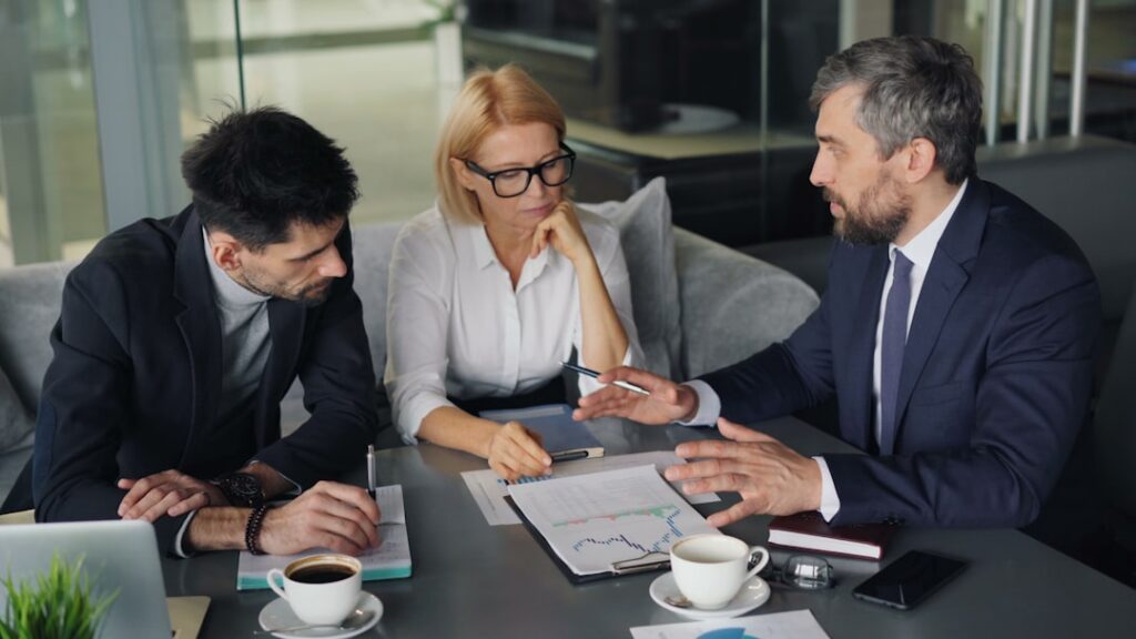 Business executives in a strategic planning meeting discussing production options and decisions